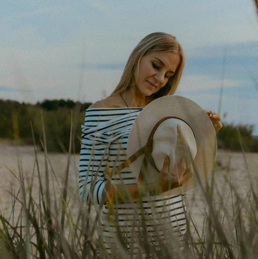 two women looking up white leaning on fence
